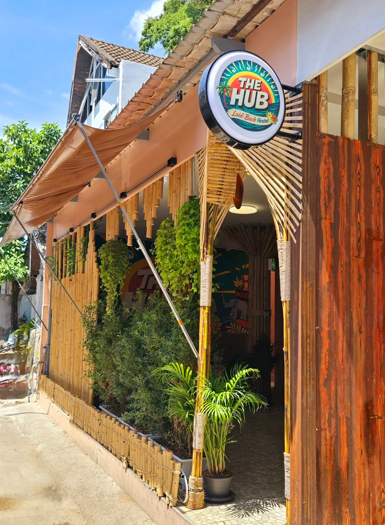 The Hub bamboo façade and round sign at the Ao Nang entrance