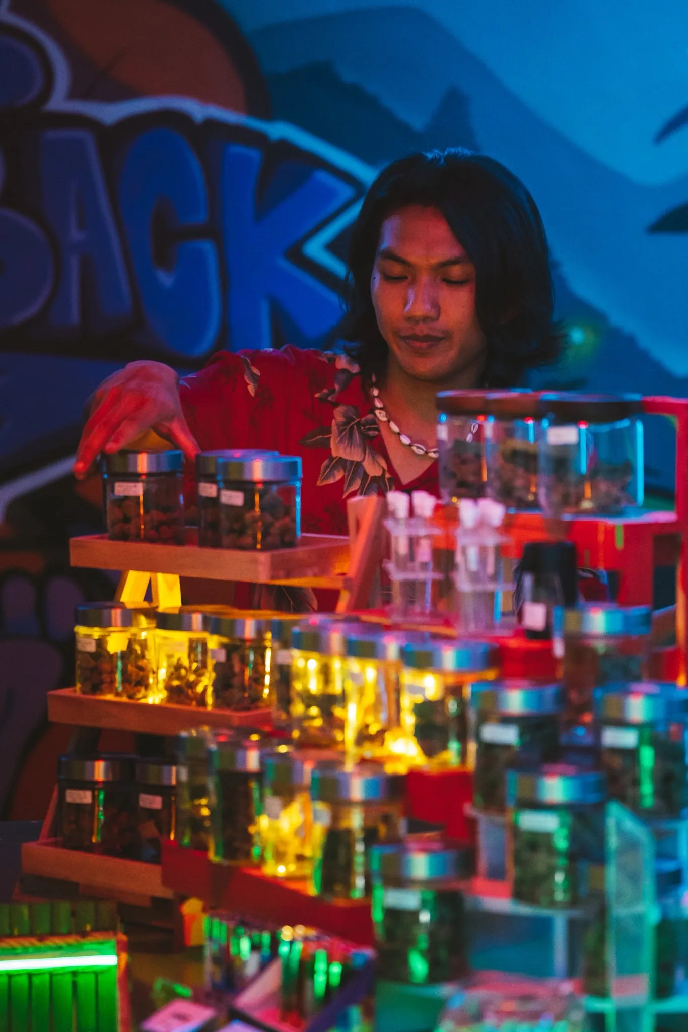 The Hub's cannabis jar display lit by neon in Ao Nang, Krabi
