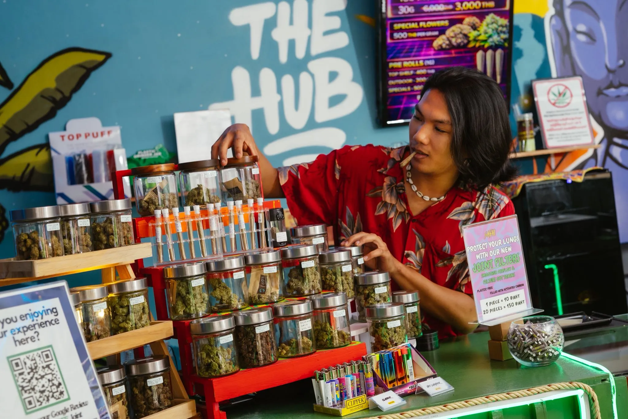 The Hub team member with the in-house cannabis jar display