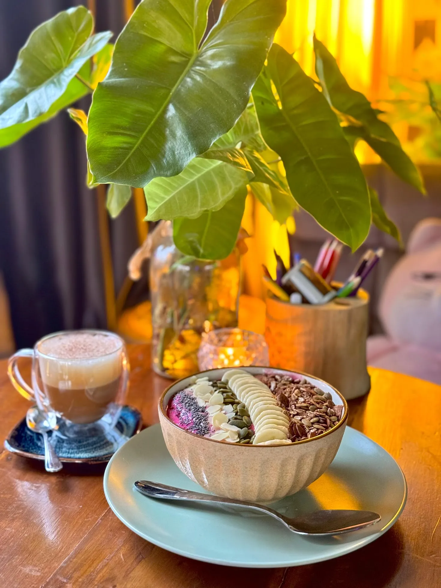 Fresh smoothie bowl and coffee on a table at The Hub